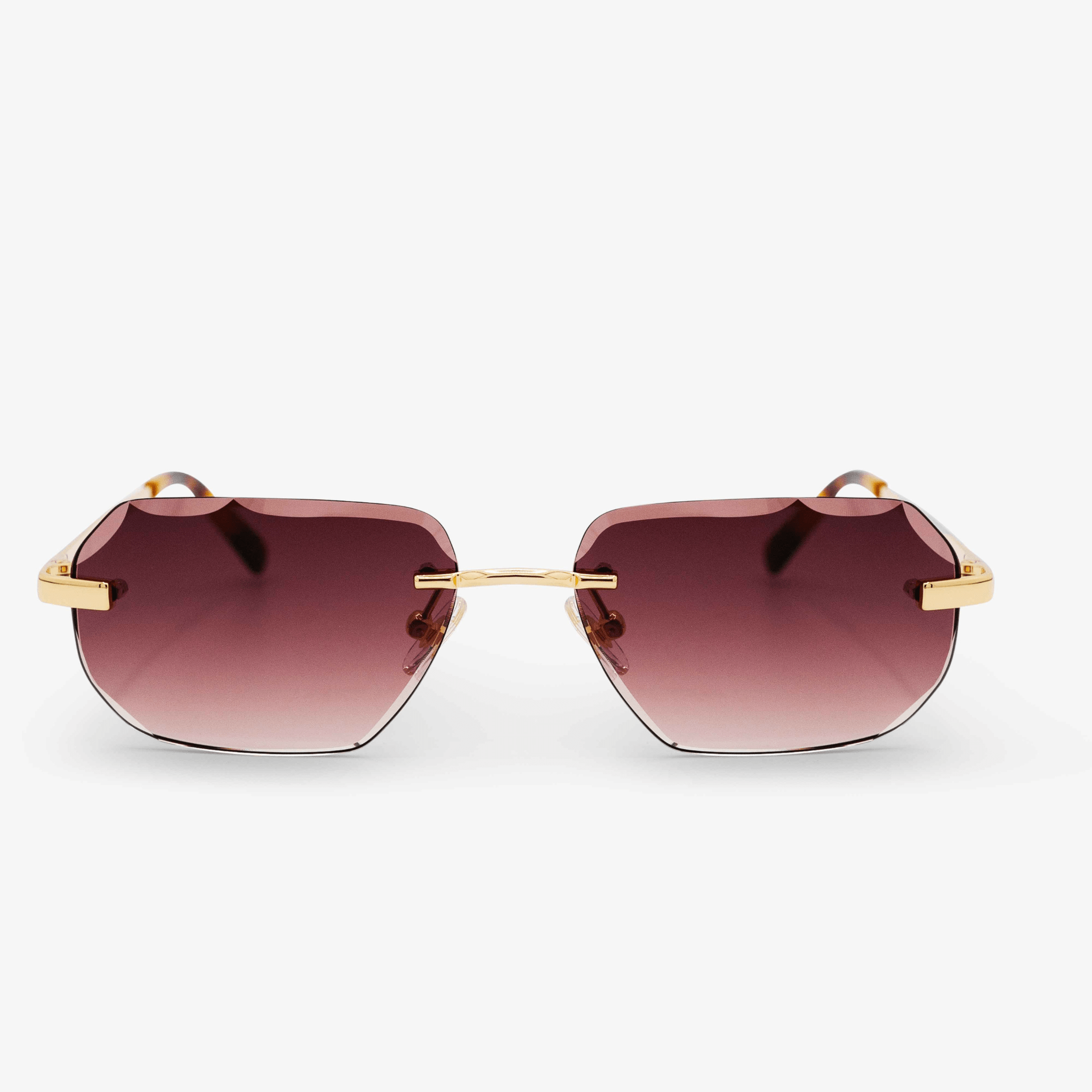 A pair of Jubilee model sunglasses with 18k gold-plated accents and rimless, diamond-cut design. The lenses have a gradient tint, transitioning from a darker shade at the top to a lighter one at the bottom.